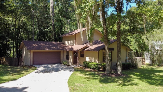 view of front of house featuring a garage, driveway, a front yard, and fence