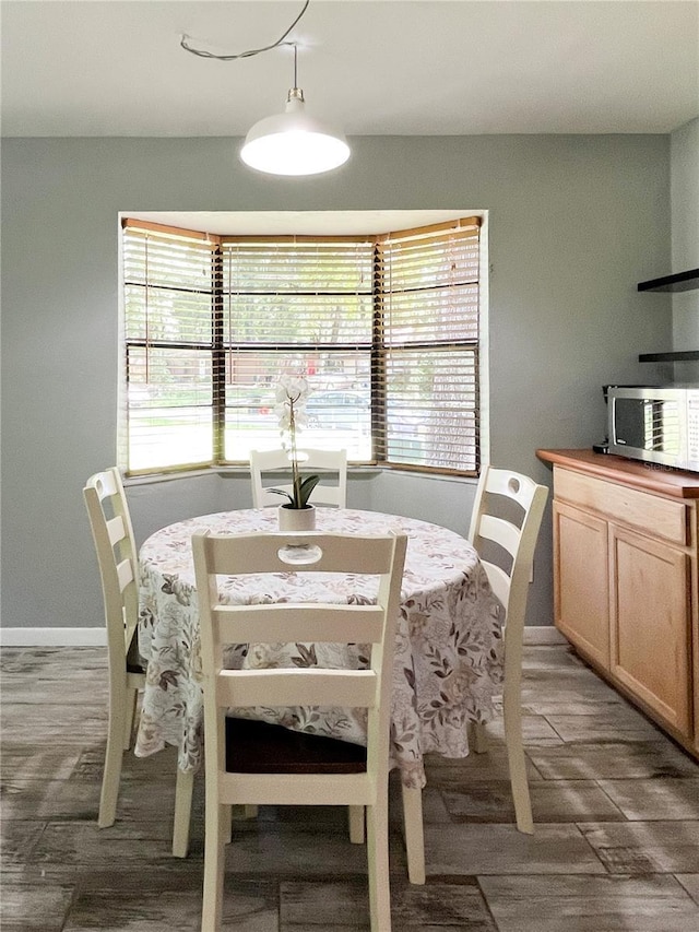 dining room featuring wood finished floors and baseboards