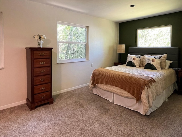 bedroom with light carpet and baseboards