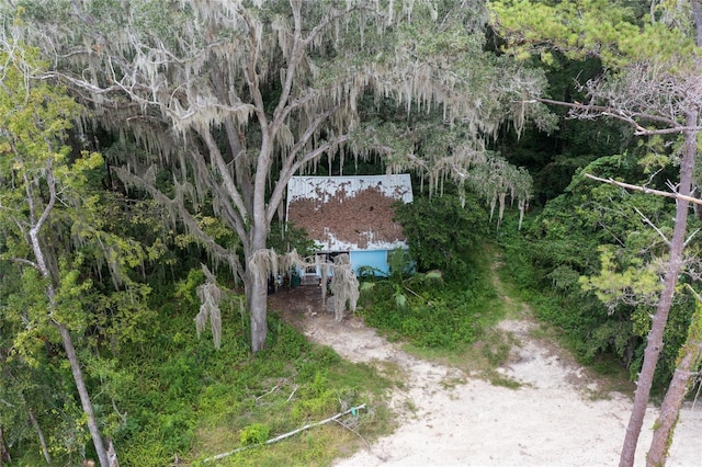 drone / aerial view featuring a forest view
