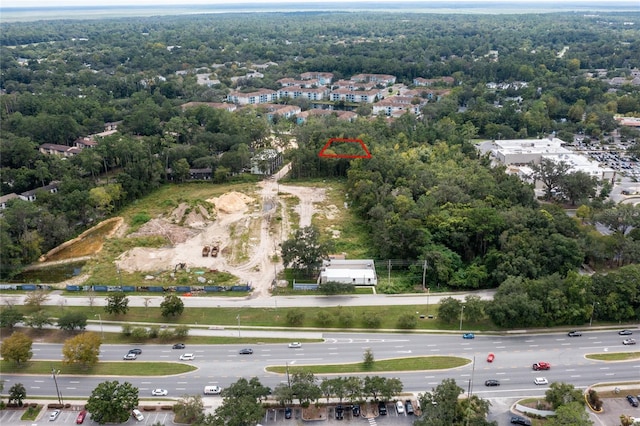 birds eye view of property featuring a view of trees