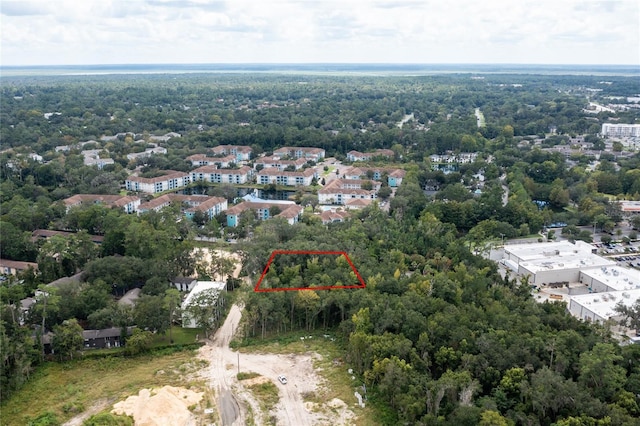 bird's eye view featuring a wooded view