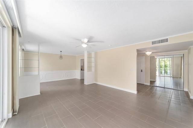 spare room featuring ceiling fan and ornamental molding