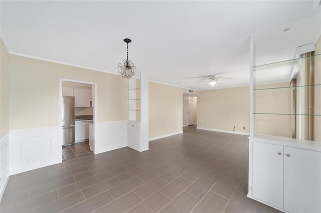 unfurnished room with ceiling fan with notable chandelier