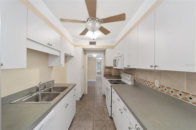 kitchen with backsplash, white appliances, sink, white cabinetry, and light tile patterned flooring