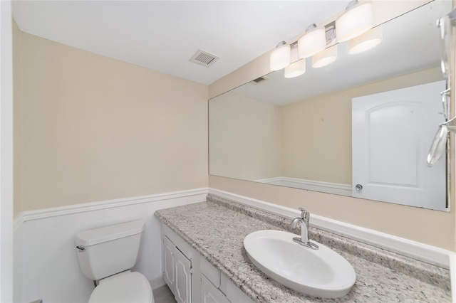 bathroom with vanity and toilet