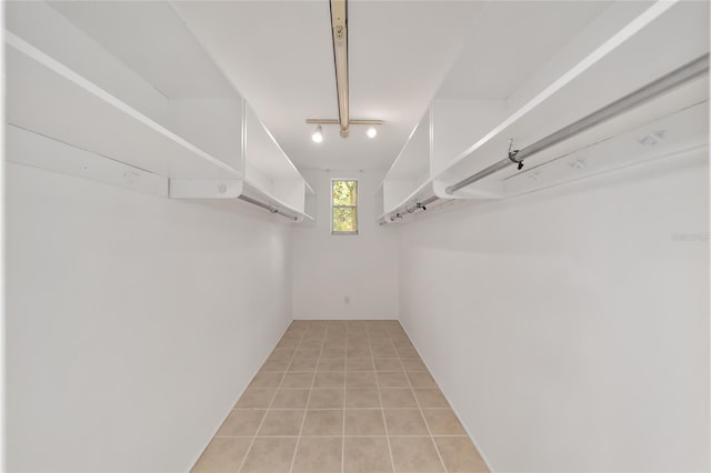 spacious closet with light tile patterned floors