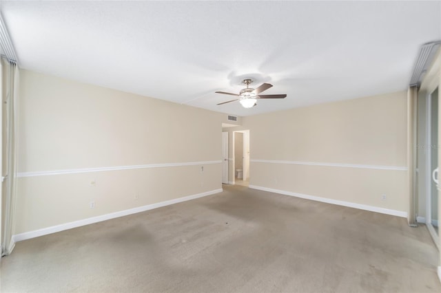 carpeted spare room with ceiling fan