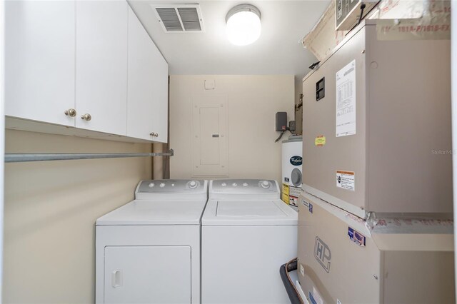 laundry area with cabinets, water heater, electric panel, heating unit, and washer and dryer