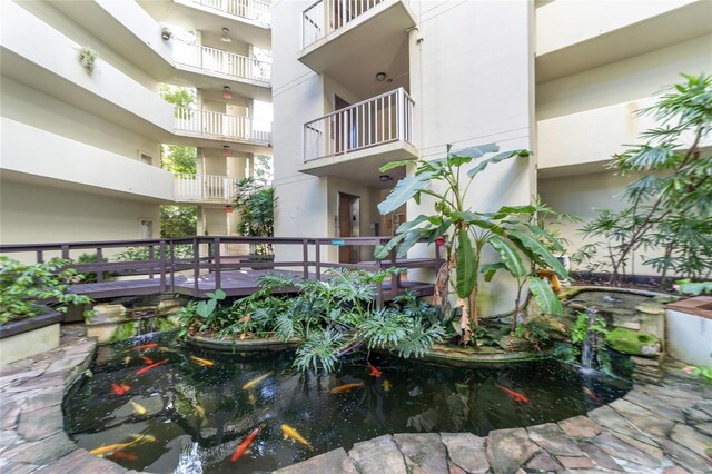 1717 NW 23rd Ave Unit 4D, Gainesville, FL 32605 - view of property's community with a garden pond