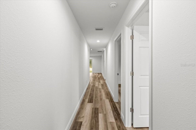 hallway with wood-type flooring