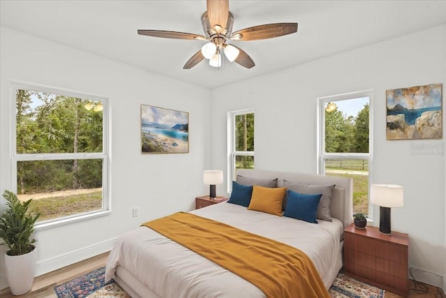 bedroom with hardwood / wood-style flooring and ceiling fan