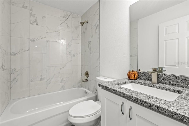 full bathroom featuring toilet, vanity, and tiled shower / bath