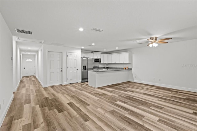 kitchen with white cabinets, sink, ceiling fan, kitchen peninsula, and stainless steel appliances