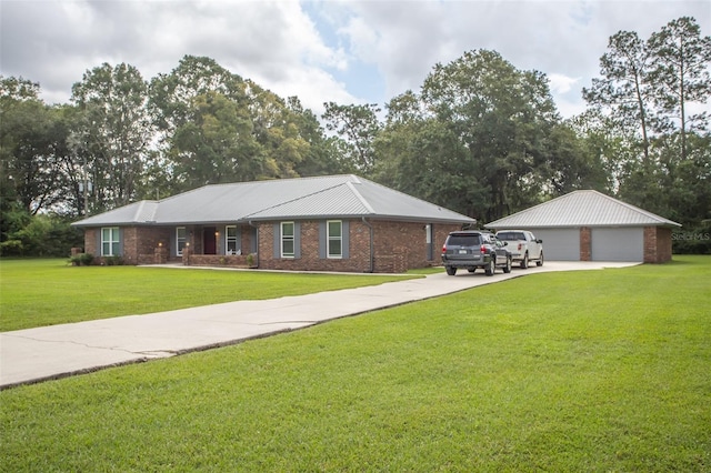 single story home with an outdoor structure, a garage, and a front lawn