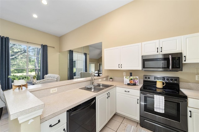 kitchen featuring dishwashing machine, stainless steel microwave, a peninsula, a sink, and range with electric stovetop