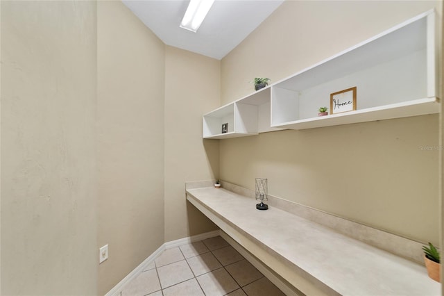 interior space with light tile patterned floors and baseboards