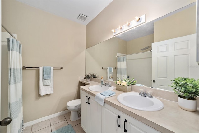 bathroom featuring tile patterned flooring, toilet, walk in shower, and vanity