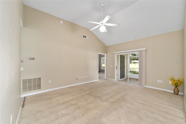 carpeted spare room with ceiling fan and high vaulted ceiling