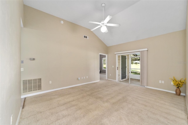 carpeted empty room featuring high vaulted ceiling, visible vents, baseboards, and a ceiling fan