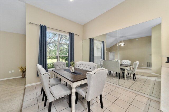 carpeted dining room featuring vaulted ceiling and ceiling fan