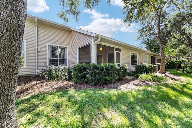 view of side of home with a lawn