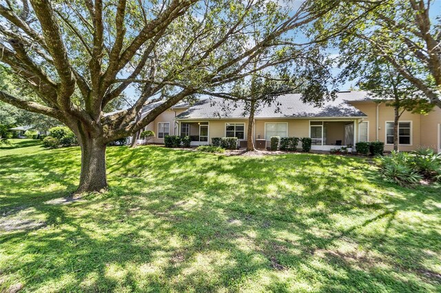 back of property featuring a lawn