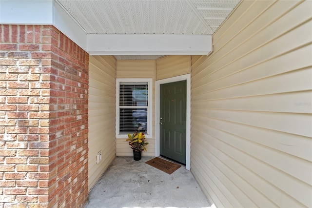 entrance to property with brick siding