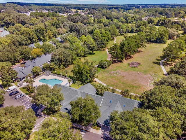 birds eye view of property featuring a wooded view