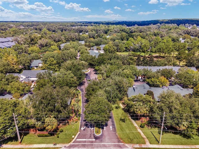 drone / aerial view with a wooded view