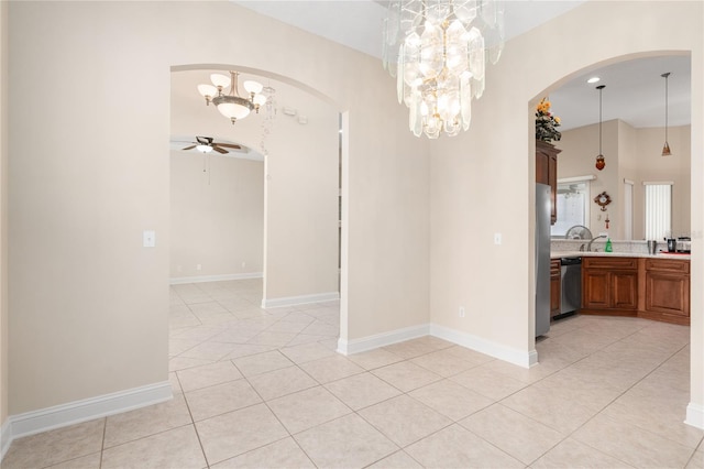 unfurnished dining area with ceiling fan with notable chandelier and light tile patterned flooring