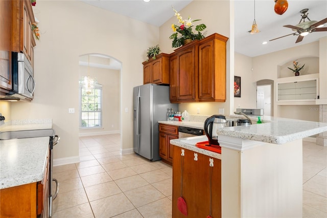 kitchen featuring ceiling fan with notable chandelier, pendant lighting, appliances with stainless steel finishes, kitchen peninsula, and light tile patterned flooring