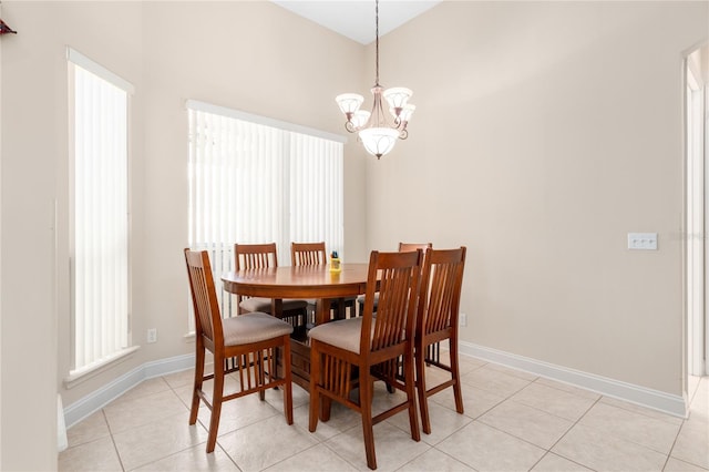 dining area featuring light tile patterned floors and an inviting chandelier