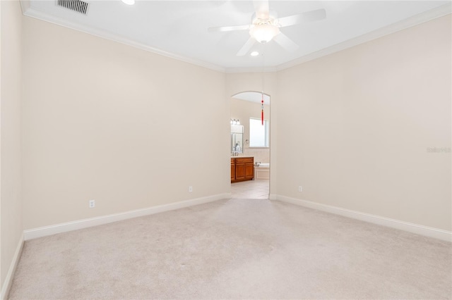 carpeted empty room with ornamental molding and ceiling fan