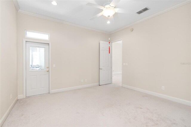 unfurnished room with ceiling fan, crown molding, and light carpet