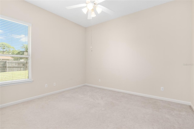 unfurnished room with light carpet and ceiling fan