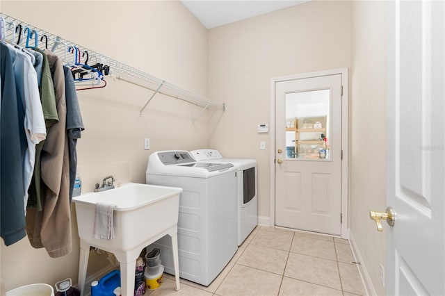 washroom with light tile patterned floors and washer and dryer