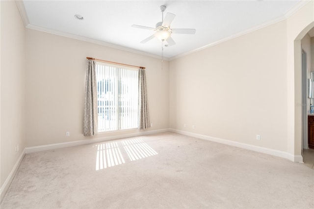 carpeted empty room featuring crown molding and ceiling fan