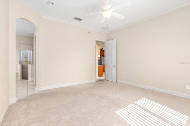 carpeted spare room featuring ornamental molding and ceiling fan