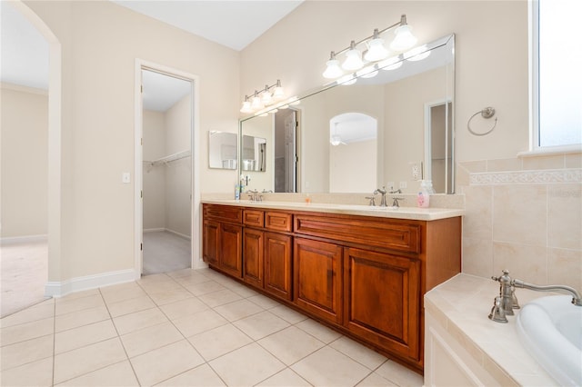 bathroom with vanity, a bath, and tile patterned floors