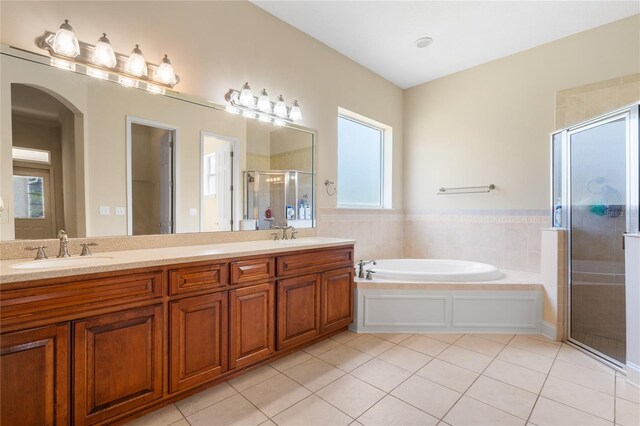 bathroom featuring tile patterned flooring, plenty of natural light, separate shower and tub, and vanity