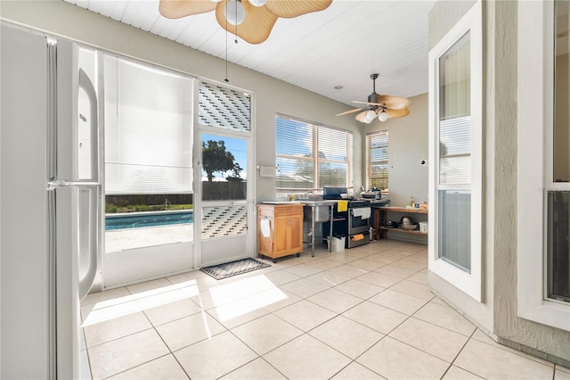 interior space with ceiling fan and light tile patterned floors