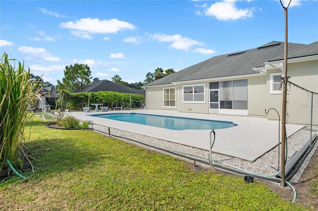 view of pool with a yard and a patio area