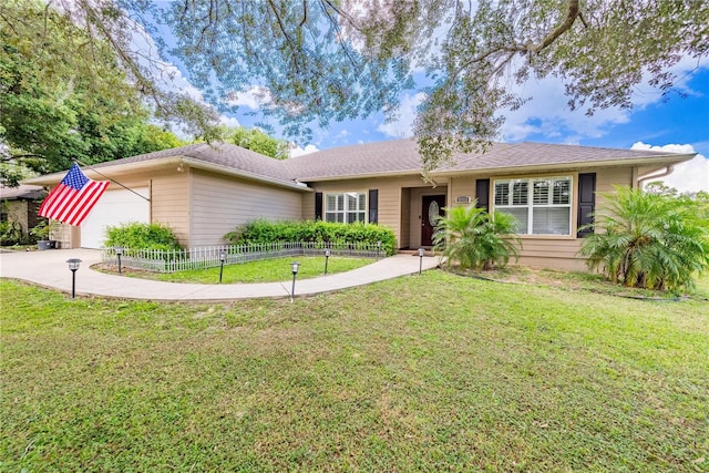 ranch-style house featuring a front lawn and a garage