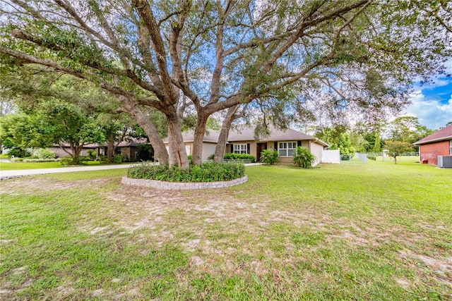 view of front of home featuring a front yard and central AC