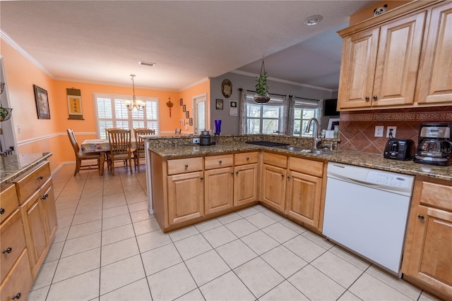 kitchen featuring white dishwasher, plenty of natural light, kitchen peninsula, and light tile patterned flooring