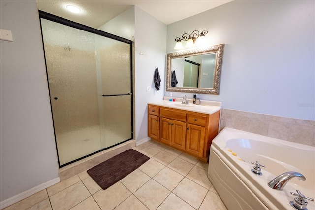 bathroom featuring tile patterned flooring, shower with separate bathtub, and vanity