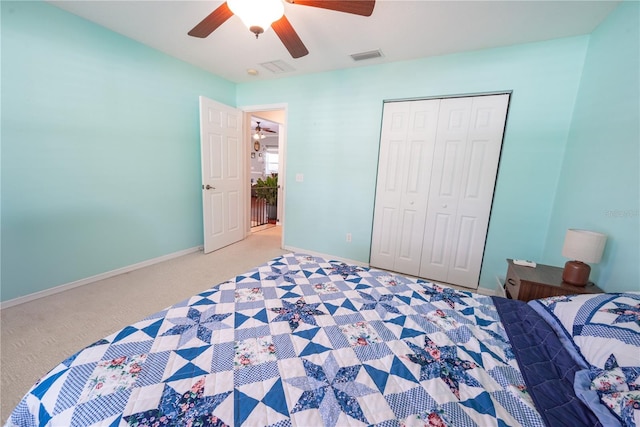 carpeted bedroom featuring a closet and ceiling fan