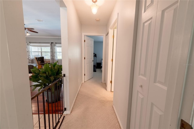 hall featuring light colored carpet