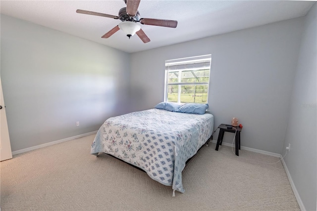 bedroom with light carpet and ceiling fan